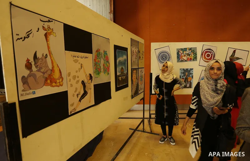 Palestinians attend the anime gallery for the disabled Mohammed Dalu, in Gaza city, on April 12, 2017. Photo by Ashraf Amra