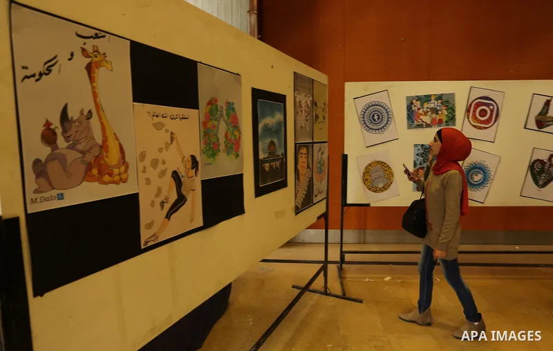 Palestinians attend the anime gallery for the disabled Mohammed Dalu, in Gaza city, on April 12, 2017. Photo by Ashraf Amra