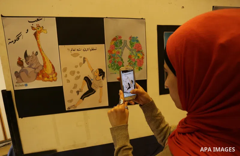 Palestinians attend the anime gallery for the disabled Mohammed Dalu, in Gaza city, on April 12, 2017. Photo by Ashraf Amra
