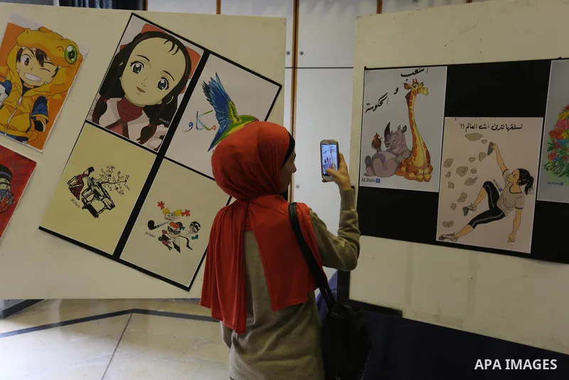 Palestinians attend the anime gallery for the disabled Mohammed Dalu, in Gaza city, on April 12, 2017. Photo by Ashraf Amra