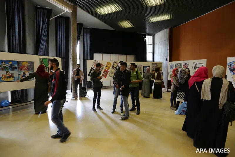 Palestinians attend the anime gallery for the disabled Mohammed Dalu, in Gaza city, on April 12, 2017. Photo by Ashraf Amra