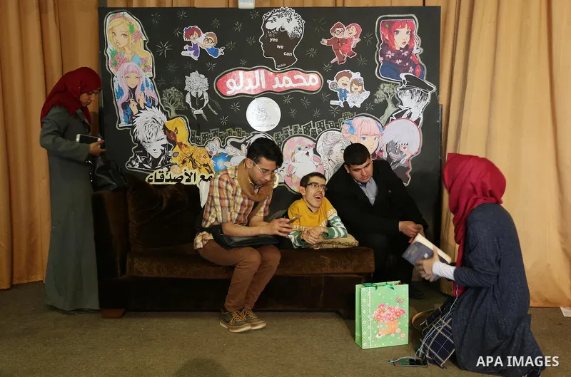 A Palestinian disabled Mohammed Dalu, opens his the anime gallery, in Gaza city, on April 12, 2017. Photo by Ashraf Amra