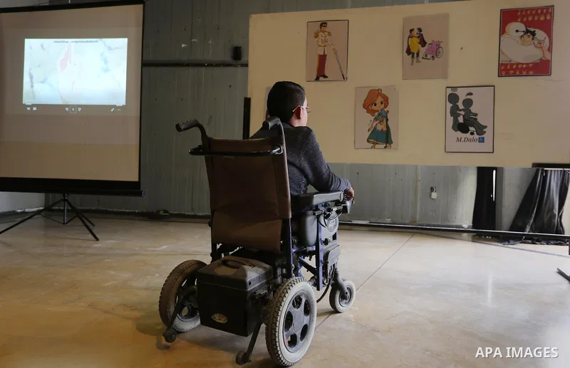 A Palestinian disabled Mohammed Dalu, opens his the anime gallery, in Gaza city, on April 12, 2017. Photo by Ashraf Amra