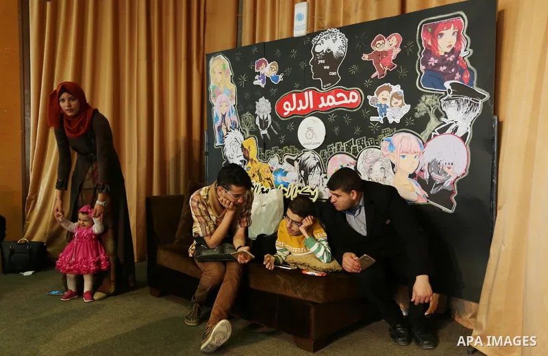 A Palestinian disabled Mohammed Dalu, opens his the anime gallery, in Gaza city, on April 12, 2017. Photo by Ashraf Amra