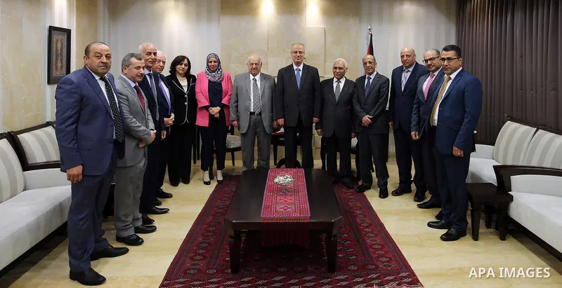 Palestinian Prime Minister, Rami Hamdallah, receives the annual report of the Anti-Corruption Commission for 2016, in the West Bank city of Ramallah, on April 13, 2017. Photo by Prime Minister Office