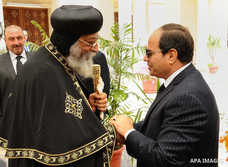 A handout picture released by the Egyptian Presidency April 13, 2017 shows Egyptian President Abdel Fattah al-Sisi offering his condolences to Coptic Pope Tawadros II at the headquarters of St. Mark's Coptic Orthodox Cat...