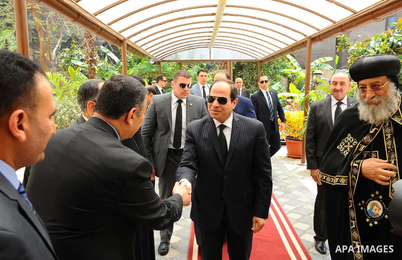 A handout picture released by the Egyptian Presidency April 13, 2017 shows Egyptian President Abdel Fattah al-Sisi offering his condolences to Coptic Pope Tawadros II at the headquarters of St. Mark's Coptic Orthodox Cat...