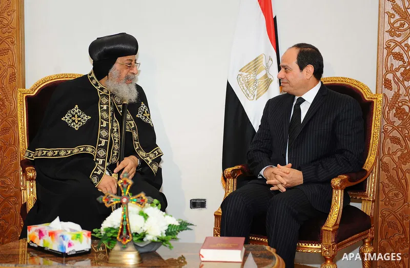 A handout picture released by the Egyptian Presidency April 13, 2017 shows Egyptian President Abdel Fattah al-Sisi offering his condolences to Coptic Pope Tawadros II at the headquarters of St. Mark's Coptic Orthodox Cat...