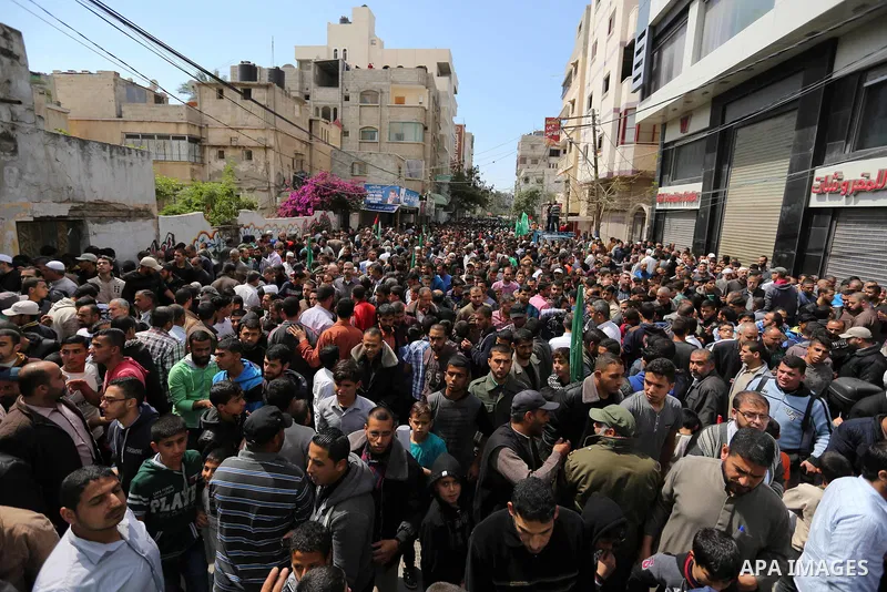 Hamas supporters hold crossed posters depicting Palestinian President Mahmoud Abbas and Palestinian Prime Minister Rami Hamdallah during a protest against them in Khan Younis in the southern Gaza Strip April 14, 2017. Ph...