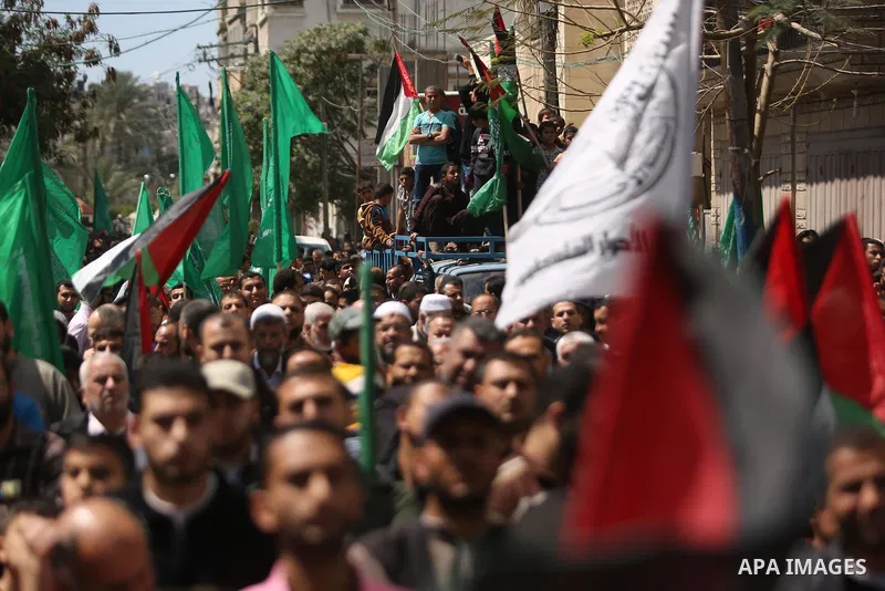 Hamas supporters hold crossed posters depicting Palestinian President Mahmoud Abbas and Palestinian Prime Minister Rami Hamdallah during a protest against them in Khan Younis in the southern Gaza Strip April 14, 2017. Ph...