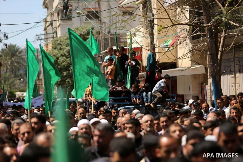 Hamas supporters hold crossed posters depicting Palestinian President Mahmoud Abbas and Palestinian Prime Minister Rami Hamdallah during a protest against them in Khan Younis in the southern Gaza Strip April 14, 2017. Ph...