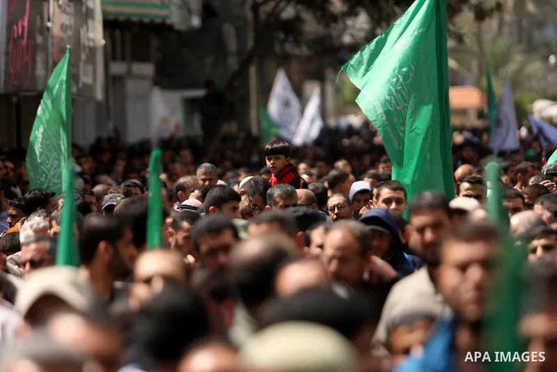 Hamas supporters hold crossed posters depicting Palestinian President Mahmoud Abbas and Palestinian Prime Minister Rami Hamdallah during a protest against them in Khan Younis in the southern Gaza Strip April 14, 2017. Ph...