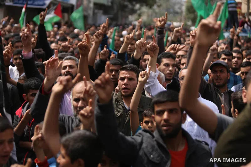 Hamas supporters hold crossed posters depicting Palestinian President Mahmoud Abbas and Palestinian Prime Minister Rami Hamdallah during a protest against them in Khan Younis in the southern Gaza Strip April 14, 2017. Ph...