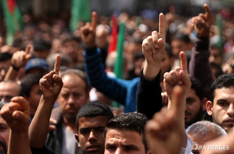 Hamas supporters hold crossed posters depicting Palestinian President Mahmoud Abbas and Palestinian Prime Minister Rami Hamdallah during a protest against them in Khan Younis in the southern Gaza Strip April 14, 2017. Ph...