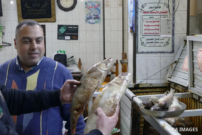 Egyptians buy the Herring or, salted fish during preparation for the upcoming the Sham El Nessim, or the Festival of Spring Breeze, which marks the beginning of spring, in Cairo, on April 14, 2017. Photo by Amr Sayed