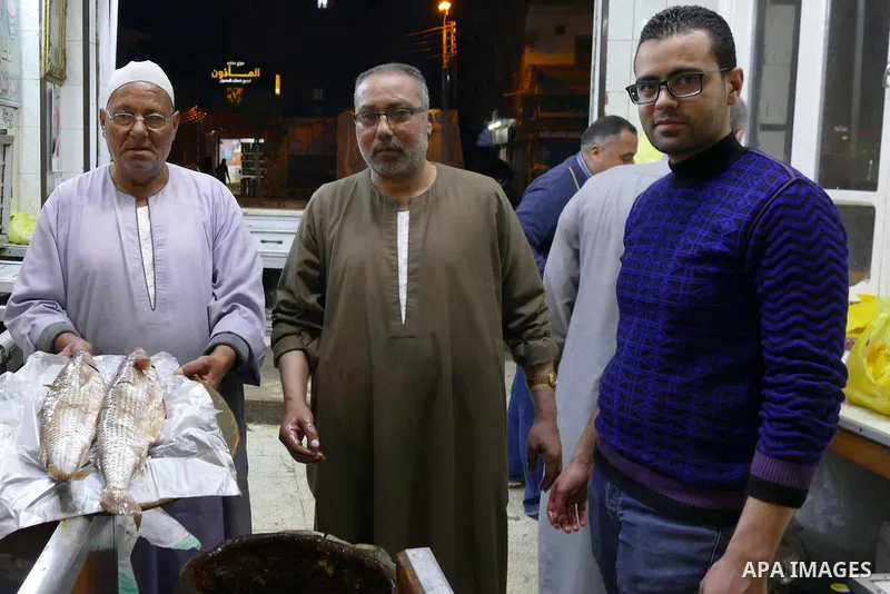 Egyptians buy the Herring or, salted fish during preparation for the upcoming the Sham El Nessim, or the Festival of Spring Breeze, which marks the beginning of spring, in Cairo, on April 14, 2017. Photo by Amr Sayed