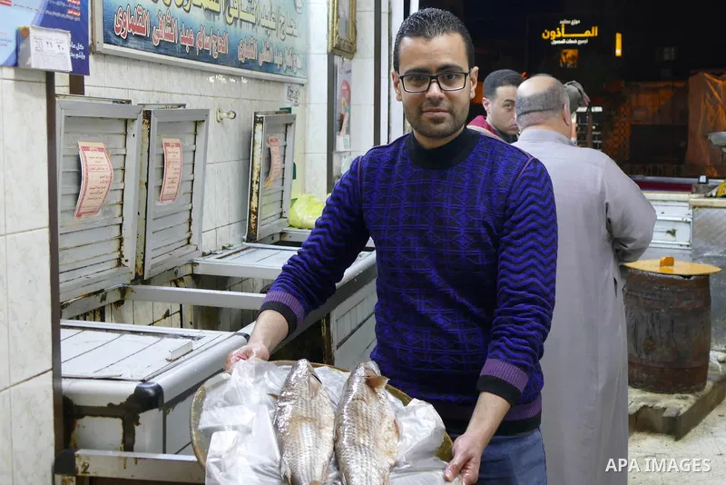 Egyptians buy the Herring or, salted fish during preparation for the upcoming the Sham El Nessim, or the Festival of Spring Breeze, which marks the beginning of spring, in Cairo, on April 14, 2017. Photo by Amr Sayed