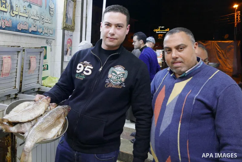 Egyptians buy the Herring or, salted fish during preparation for the upcoming the Sham El Nessim, or the Festival of Spring Breeze, which marks the beginning of spring, in Cairo, on April 14, 2017. Photo by Amr Sayed