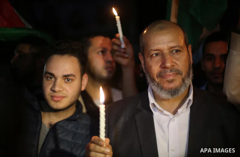 Supporters of the Palestinian Hamas movement hold placards and light candles during a protest against the Israeli blockade of the Gaza Strip, in Gaza city, on April 14, 2017. Photo by Mohammed Asad