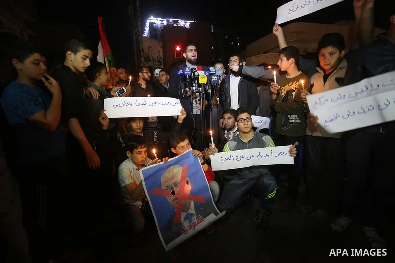 Supporters of the Palestinian Hamas movement hold placards and light candles during a protest against the Israeli blockade of the Gaza Strip, in Gaza city, on April 14, 2017. Photo by Mohammed Asad