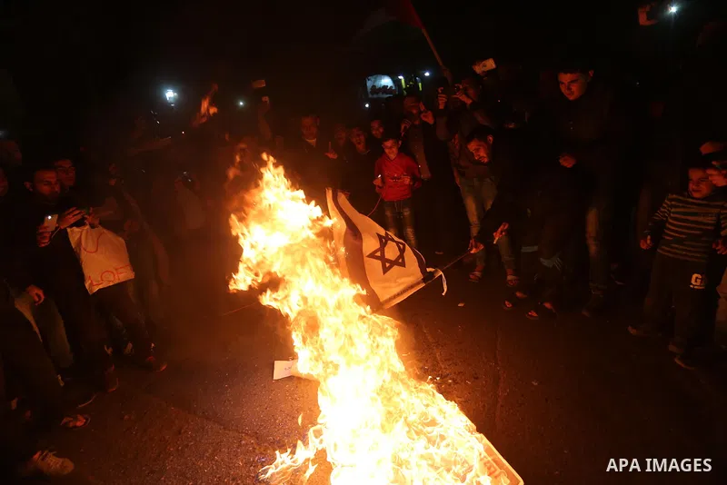Supporters of the Palestinian Hamas movement burn an Israeli flag during a protest against the Israeli blockade of the Gaza Strip, in Gaza city, on April 14, 2017. Photo by Mohammed Asad