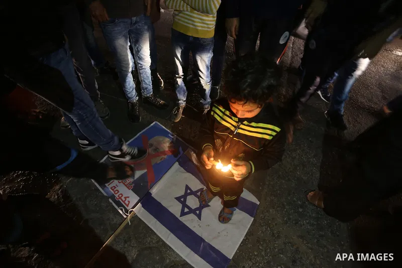 Supporters of the Palestinian Hamas movement hold placards and light candles during a protest against the Israeli blockade of the Gaza Strip, in Gaza city, on April 14, 2017. Photo by Mohammed Asad