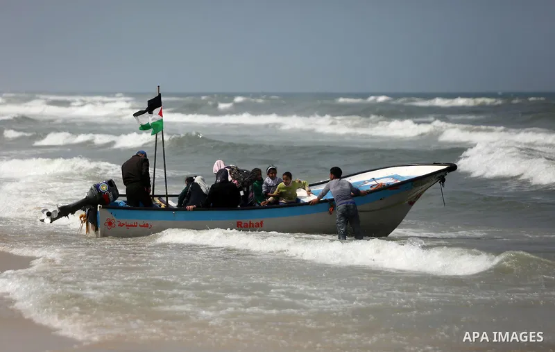 Palestinians ride a boat in the Mediterranean sea on the coast of Gaza city, on April 15, 2017. Photo by Ashraf Amra