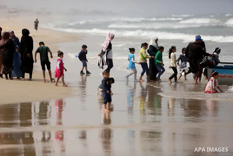 Palestinians enjoy their time at the beach of the Mediterranean sea on the coast of Gaza city, on April 15, 2017. Photo by Ashraf Amra