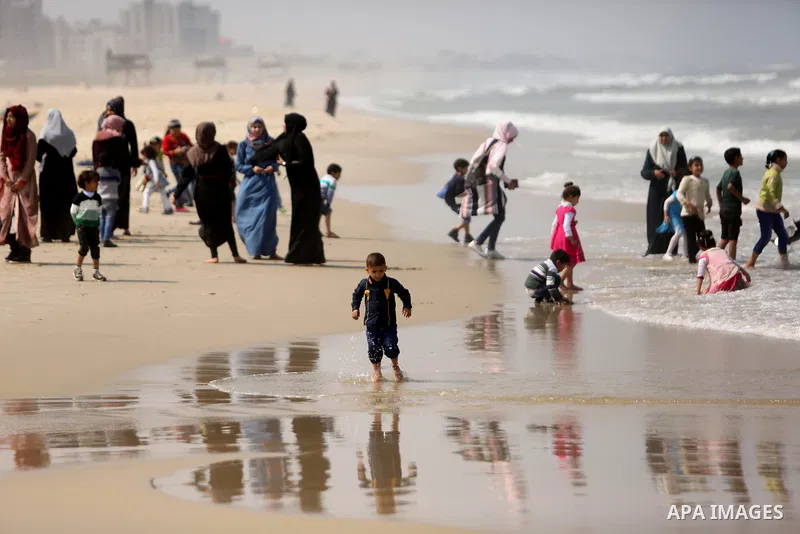 Palestinians enjoy their time at the beach of the Mediterranean sea on the coast of Gaza city, on April 15, 2017. Photo by Ashraf Amra