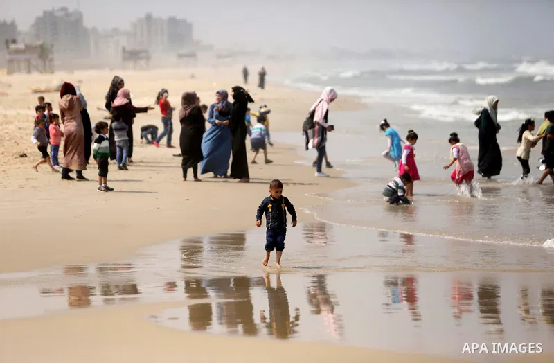 Palestinians enjoy their time at the beach of the Mediterranean sea on the coast of Gaza city, on April 15, 2017. Photo by Ashraf Amra