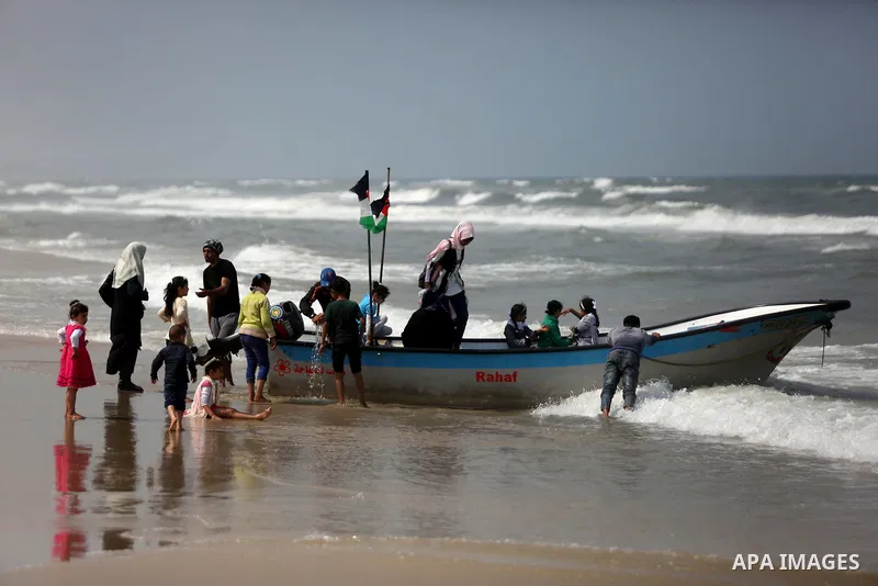 Palestinians ride a boat in the Mediterranean sea on the coast of Gaza city, on April 15, 2017. Photo by Ashraf Amra