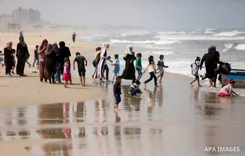 Palestinians enjoy their time at the beach of the Mediterranean sea on the coast of Gaza city, on April 15, 2017. Photo by Ashraf Amra