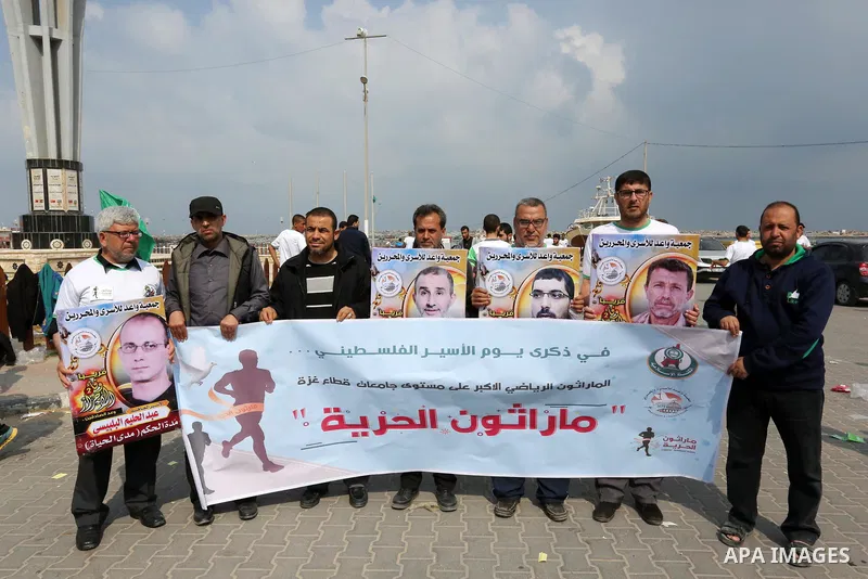 Palestinians hold banners as they take part in "Freedom Marathon" against the Israeli blockade of the Gaza Strip, in Gaza city on April 15, 2017. Photo by Ashraf Amra