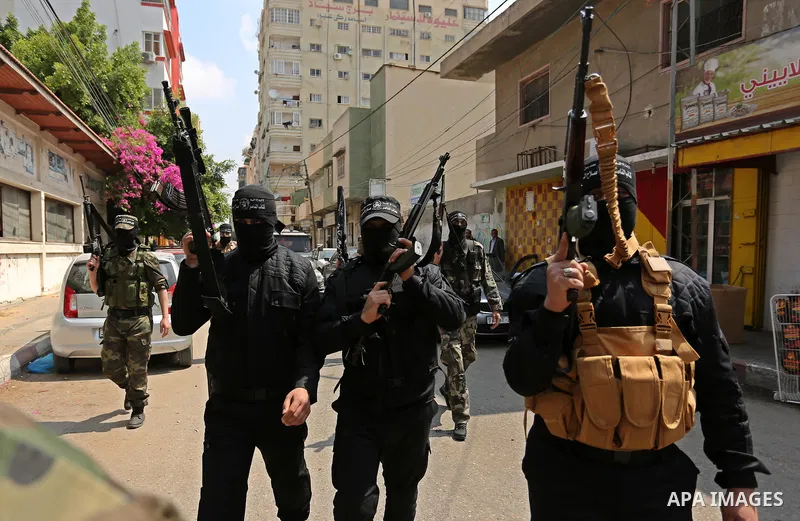 Palestinian militants of the Nasser Salah al-Din Brigades the military wing of the Popular Resistance movement arrive before a press conference, in Gaza City on April 15, 2017. Photo by Ashraf Amra