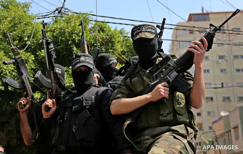 Palestinian militants of the Nasser Salah al-Din Brigades the military wing of the Popular Resistance movement arrive before a press conference, in Gaza City on April 15, 2017. Photo by Ashraf Amra