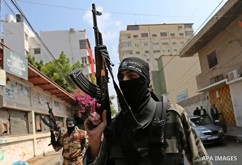 Palestinian militants of the Nasser Salah al-Din Brigades the military wing of the Popular Resistance movement arrive before a press conference, in Gaza City on April 15, 2017. Photo by Ashraf Amra