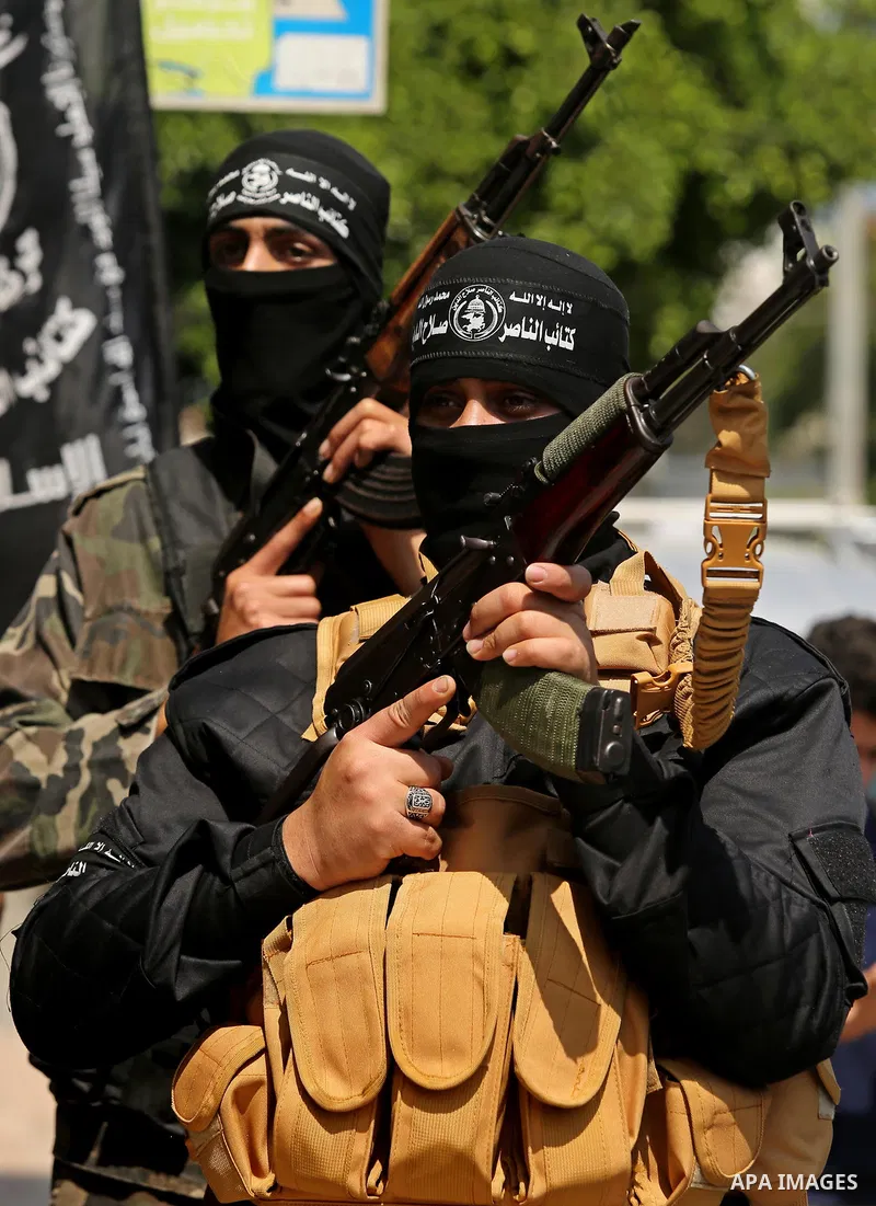 Palestinian militants of the Nasser Salah al-Din Brigades the military wing of the Popular Resistance movement hold their weapons during a press conference, in Gaza City on April 15, 2017. Photo by Ashraf Amra