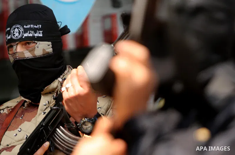 Palestinian militants of the Nasser Salah al-Din Brigades the military wing of the Popular Resistance movement hold their weapons during a press conference, in Gaza City on April 15, 2017. Photo by Ashraf Amra
