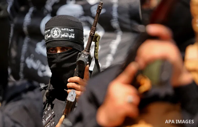 Palestinian militants of the Nasser Salah al-Din Brigades the military wing of the Popular Resistance movement hold their weapons during a press conference, in Gaza City on April 15, 2017. Photo by Ashraf Amra