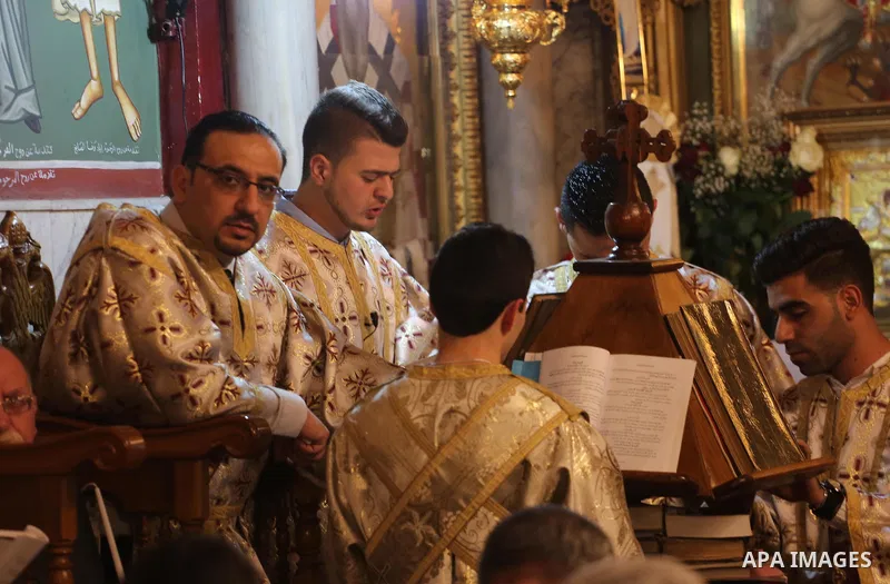 Orthodox Christian worshippers attend a prayer during the Easter Eve mass at the St. Porphyrios church in Gaza City, Saturday, April 15, 2017. Christians have gathered at the church for the fire ceremony that celebrates...
