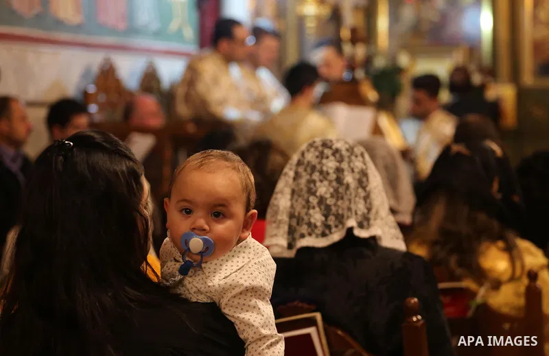 Orthodox Christian worshippers attend a prayer during the Easter Eve mass at the St. Porphyrios church in Gaza City, Saturday, April 15, 2017. Christians have gathered at the church for the fire ceremony that celebrates...