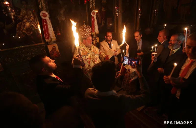 Orthodox Christian worshippers attend a prayer during the Easter Eve mass at the St. Porphyrios church in Gaza City, Saturday, April 15, 2017. Christians have gathered at the church for the fire ceremony that celebrates...