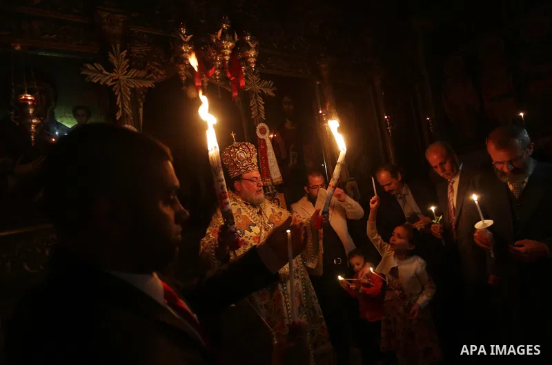 Orthodox Christian worshippers attend a prayer during the Easter Eve mass at the St. Porphyrios church in Gaza City, Saturday, April 15, 2017. Christians have gathered at the church for the fire ceremony that celebrates...
