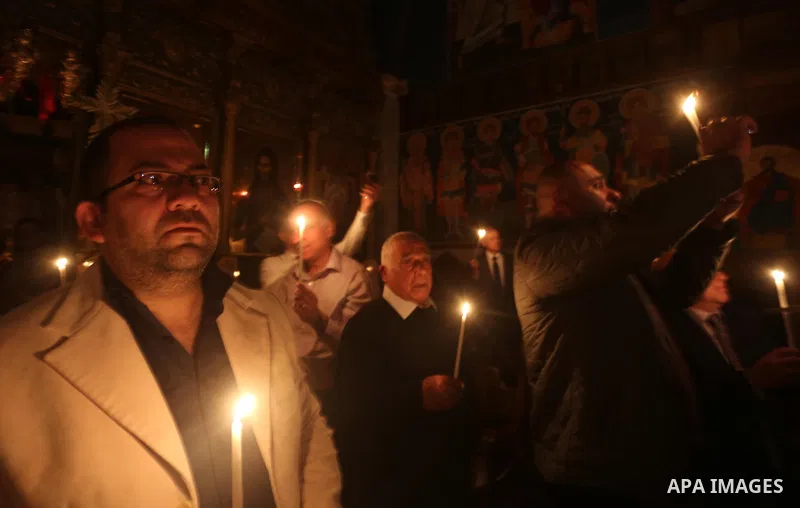 Orthodox Christian worshippers attend a prayer during the Easter Eve mass at the St. Porphyrios church in Gaza City, Saturday, April 15, 2017. Christians have gathered at the church for the fire ceremony that celebrates...