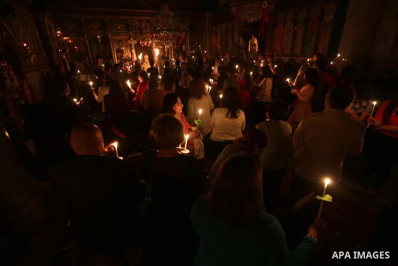 Orthodox Christian worshippers attend a prayer during the Easter Eve mass at the St. Porphyrios church in Gaza City, Saturday, April 15, 2017. Christians have gathered at the church for the fire ceremony that celebrates...