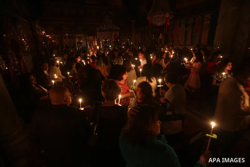 Orthodox Christian worshippers attend a prayer during the Easter Eve mass at the St. Porphyrios church in Gaza City, Saturday, April 15, 2017. Christians have gathered at the church for the fire ceremony that celebrates...