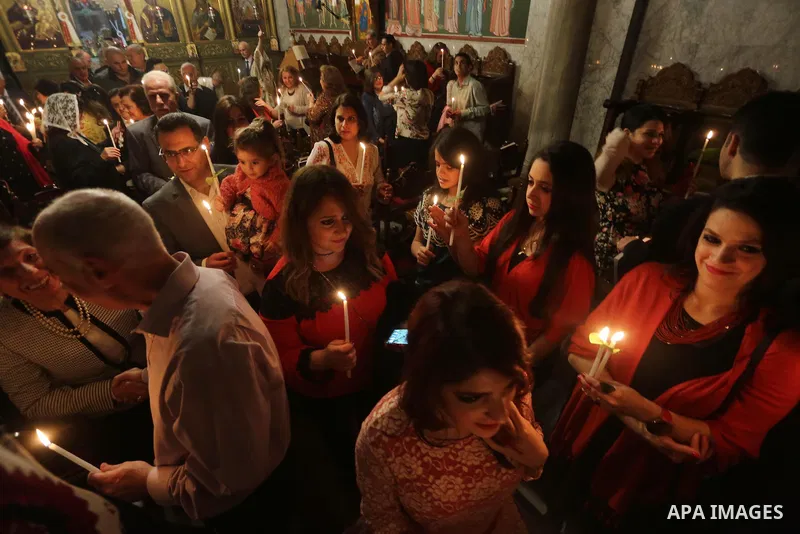 Orthodox Christian worshippers attend a prayer during the Easter Eve mass at the St. Porphyrios church in Gaza City, Saturday, April 15, 2017. Christians have gathered at the church for the fire ceremony that celebrates...