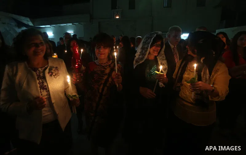 Orthodox Christian worshippers attend a prayer during the Easter Eve mass at the St. Porphyrios church in Gaza City, Saturday, April 15, 2017. Christians have gathered at the church for the fire ceremony that celebrates...