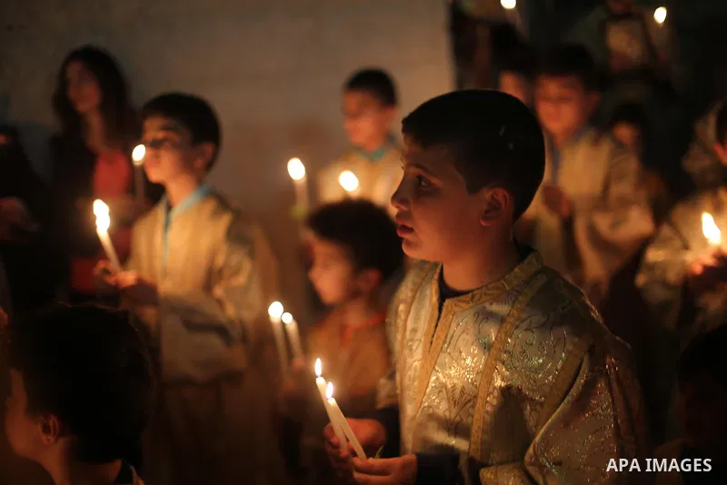 Orthodox Christian worshippers attend a prayer during the Easter Eve mass at the St. Porphyrios church in Gaza City, Saturday, April 15, 2017. Christians have gathered at the church for the fire ceremony that celebrates...