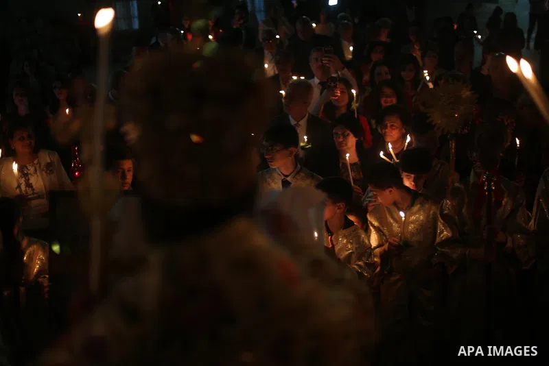 Orthodox Christian worshippers attend a prayer during the Easter Eve mass at the St. Porphyrios church in Gaza City, Saturday, April 15, 2017. Christians have gathered at the church for the fire ceremony that celebrates...